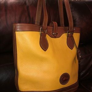 Authentic Dooney & Burke Mustard Bucket purse 12w 11t 6d 10 inch strap drop.